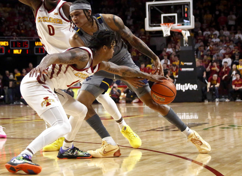 Iowa State guard Keshon Gilbert, left, steals the ball away from West Virginia guard RaeQuan Battle (21) in the first half during an NCAA college basketball game, Saturday, Feb. 24, 2024, in Ames, Iowa. (AP Photo/Bryon Houlgrave)