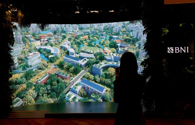 FILE PHOTO: An attendee films a video presentation of Indonesia's new planned capital Nusantara, at Ecosperity Week in Singapore