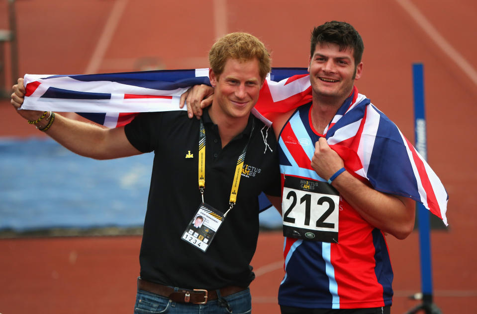 LONDON, ENGLAND - SEPTEMBER 11:  David Henson of Great Britain celebrates with Prince Harry after winning the gold medal in the 200m Men Ambulant IT2 final during day 1 of the Invictus Games, presented by Jaguar Land Rover at Lee Valley Athletics Centre on September 11, 2014 in London, England.  (Photo by Paul Thomas/Getty Images for Jaguar Land Rover)