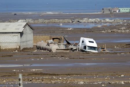 A truck partially submerged in mud is seen at a flooded area at Chanaral town, March 27, 2015. REUTERS/Ivan Alvarado