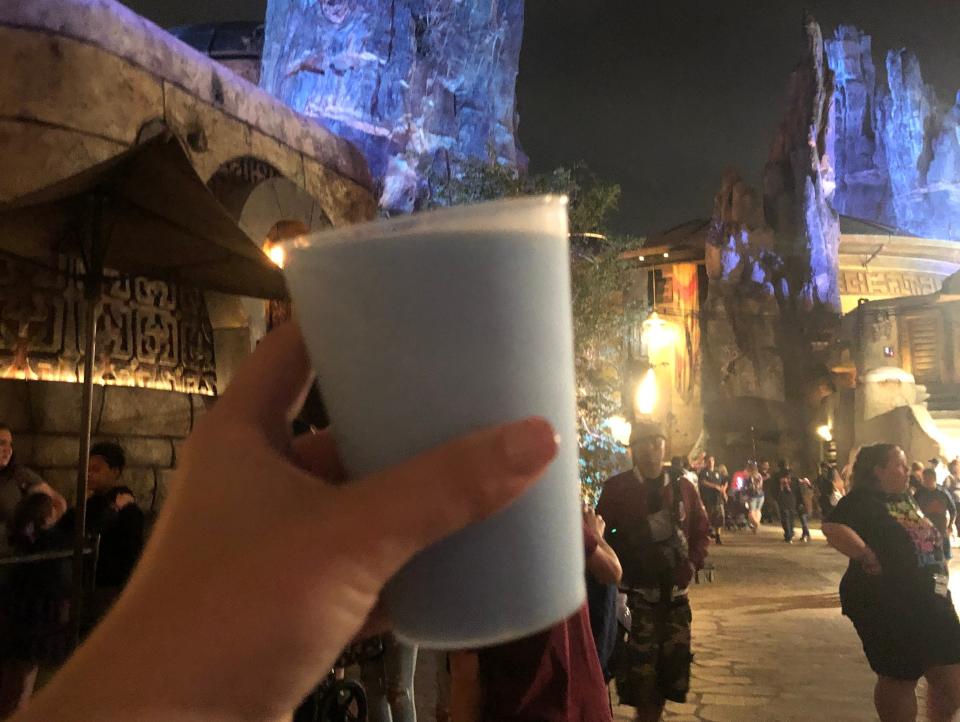 hand holding cup of blue milk in galaxy's edge at hollywood studios