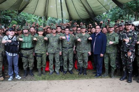 Philippine President Rodrigo Duterte (C) gestures among military officials during his visit at the military camp in Marawi city, southern Philippines July 20, 2017. Malacanang presidential palace/Handout via Reuters