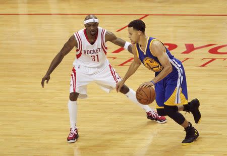 May 23, 2015; Houston, TX, USA; Golden State Warriors guard Stephen Curry (30) dribbles as Houston Rockets guard Jason Terry (31) defends during the third quarter in game three of the Western Conference Finals of the NBA Playoffs at Toyota Center. Thomas B. Shea-USA TODAY Sports