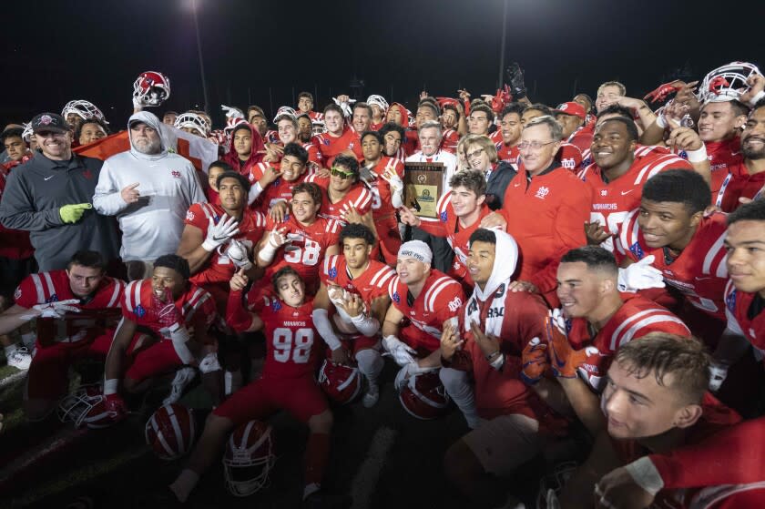Long Beach, CA - November 26: Mater Dei players pose for photos after defeating Servite.