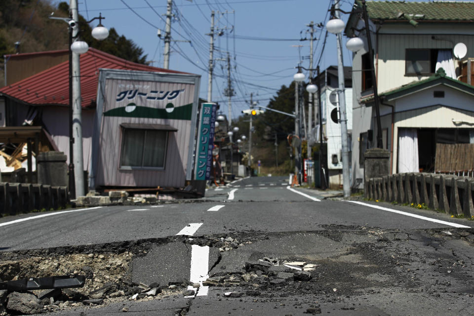 FILE - This April 17, 2011 file photo shows damage on a street in Futaba, the town where the tsunami crippled Fukushima Dai-ichi nuclear power plant is located, in Fukushima Prefecture, northeastern Japan. After the March 2011 disaster, of all Fukushima communities forced to evacuate, Futaba chose the farthest spot from the nuclear plant - an abandoned high school in Saitama Prefecture, near Tokyo. Atsushi Funahashi, director of “Nuclear Nation,” documented a story of the residents of Futaba in the film. The catastrophe in Japan has set off a flurry of independent films telling the stories of regular people who became overnight victims, stories the creators feel are being ignored by mainstream media and often silenced by the authorities. Nearly two years after the quake and tsunami disaster, the films are an attempt by the creative minds of Japan’s movie industry not only to confront the horrors of the worst nuclear disaster since Chernobyl, but also as a legacy and to empower the victims by telling their story for international audiences. (AP Photo/Hiro Komae, File)