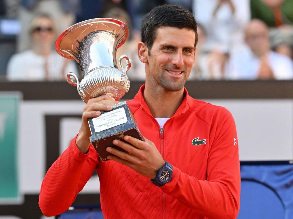 Serbia's Novak Djokovic holds the winner's trophy after winning the final match of the Men's ATP Rome Open tennis tournament against Greece's Stefanos Tsitsipas