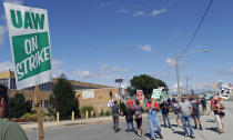 Picketers walk the picket line outside the General Motors Fabrication Division, Monday, Sept. 23, 2019, in Parma, Ohio. The strike against General Motors by 49,000 United Auto Workers entered its second week Monday with progress reported in negotiations but no clear end in sight. (AP Photo/Tony Dejak)