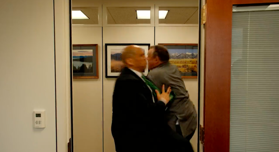 The two senators are seen colliding outside a boardroom where their respective chief of staffs admonish them for ‘tackling in the Capitol’ (Jon Tester/Twitter)