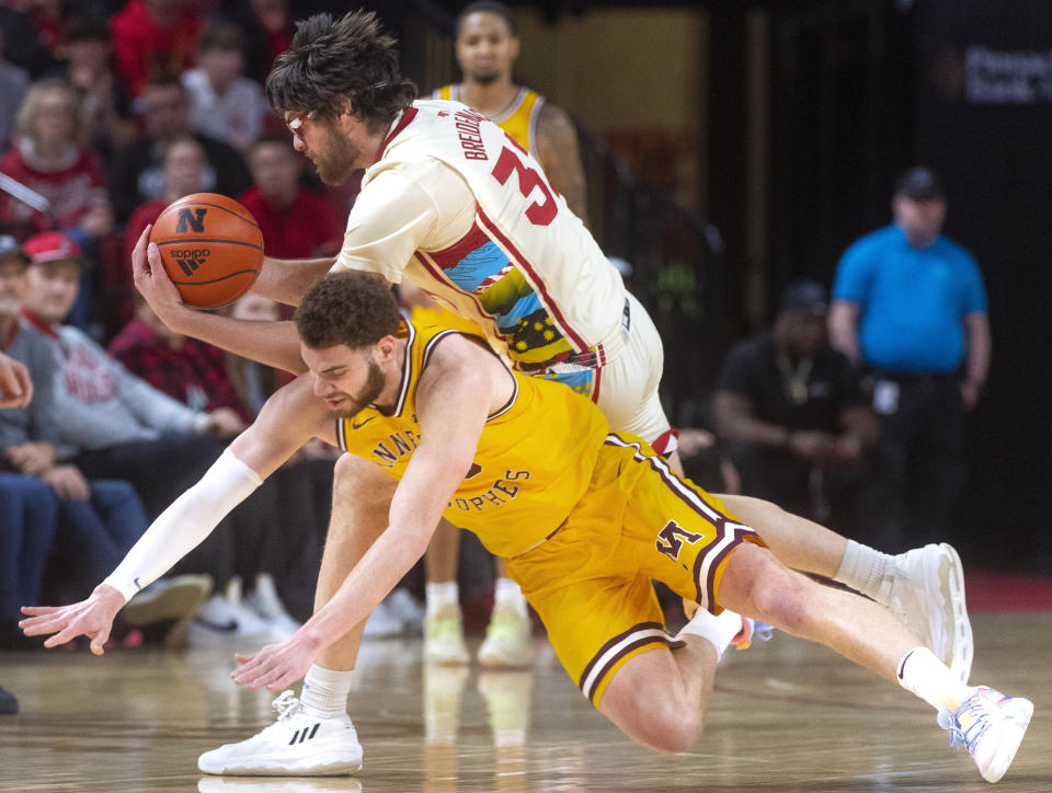 Nebraska's Wilhelm Brenidenbach, top, and Minnesota's Jamison Battle vie for a loose ball during the first half of an NCAA college basketball game, Saturday, Feb. 25, 2023, at Pinnacle Bank Arena in Lincoln, Neb. (Kenneth Ferriera/Lincoln Journal Star via AP)