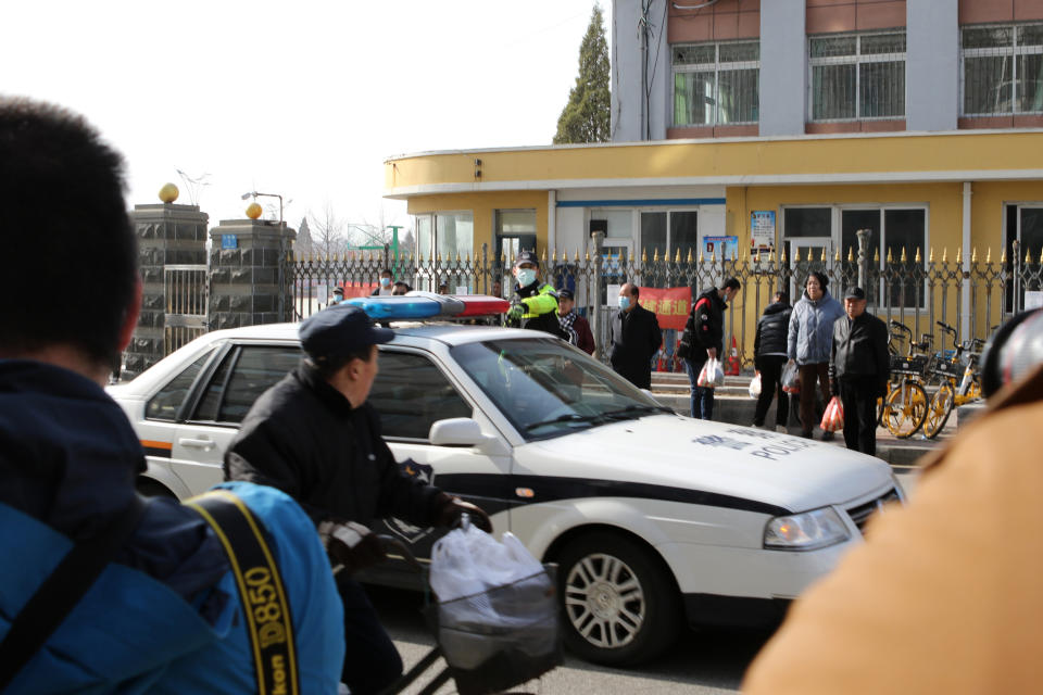 A police vehicle arrives at a court building in Dandong in northeastern China's Liaoning Province, Friday, March 19, 2021. China was expected to open the first trial Friday for Michael Spavor, one of two Canadians who have been held for more than two years in apparent retaliation for Canada's arrest of a senior Chinese telecom executive. (AP Photo/Ken Moritsugu)
