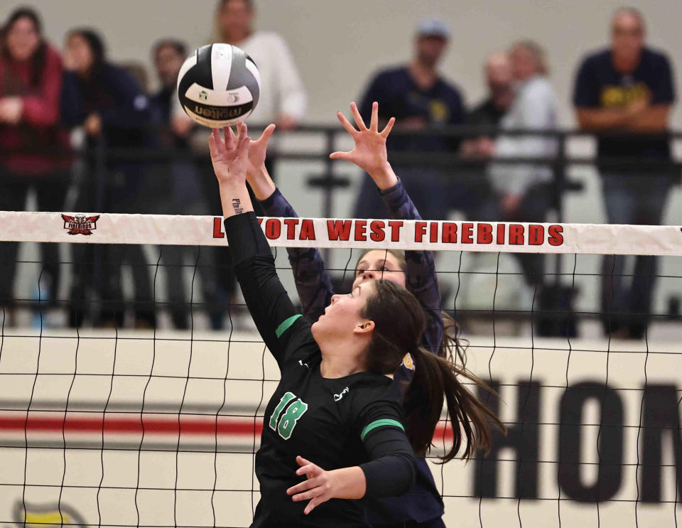 Seton's Reagan Miller (18) meets St. Ursula player Molly Dorger (7) during their regional volleyball game Thursday, Nov. 2, 2023.