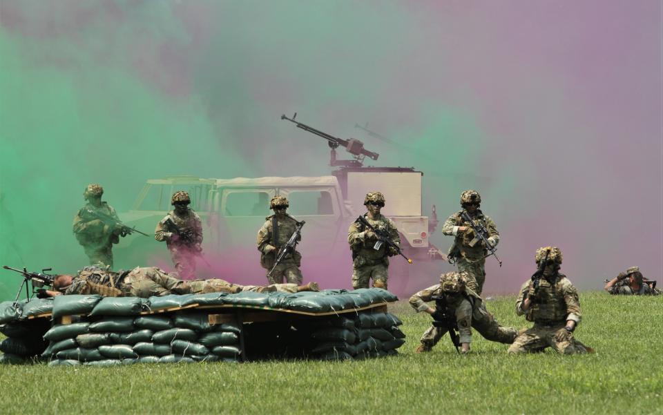 Marching out of a cloud of smoke at the air assault demonstration.