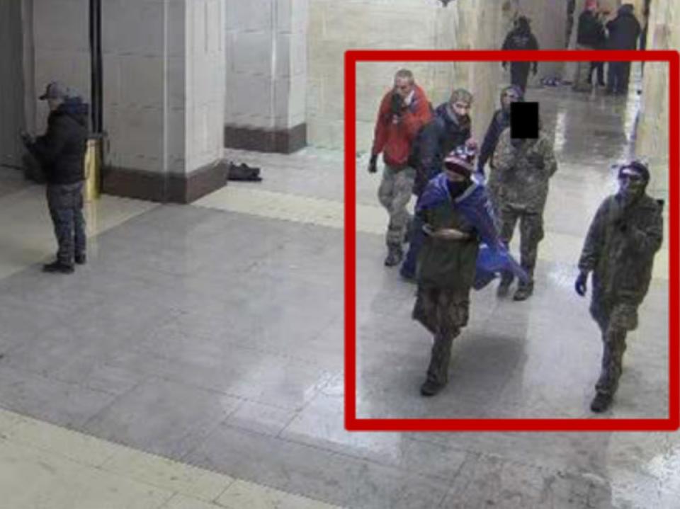 The Munn family appears on surveillance footage walking around the interior of the Capitol building (Justice Department)