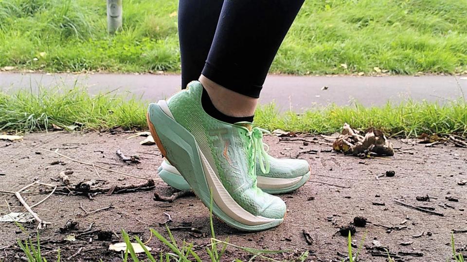 Woman's feet wearing Hoka Mach X running shoes