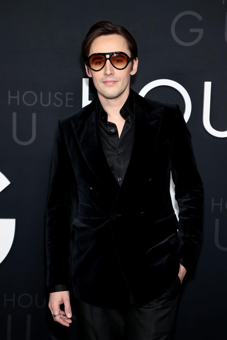 An actor in a black suit at the "House Of Gucci" New York premiere.