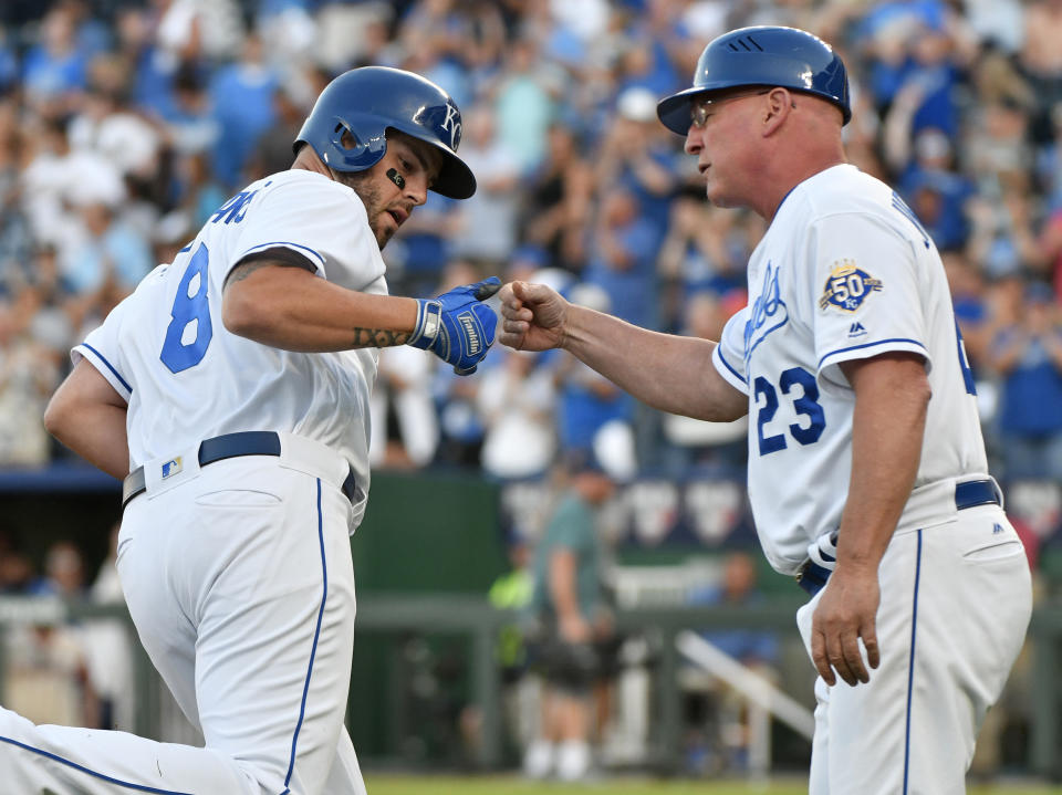 Kansas City Royals Mike Moustakas (8) celebrates his two-run home run with third base coach Mike Jirschele (23) during the first inning of the team's baseball game against the Detroit Tigers on Tuesday, July 24, 2018, in Kansas City, Mo. (AP Photo/Ed Zurga)