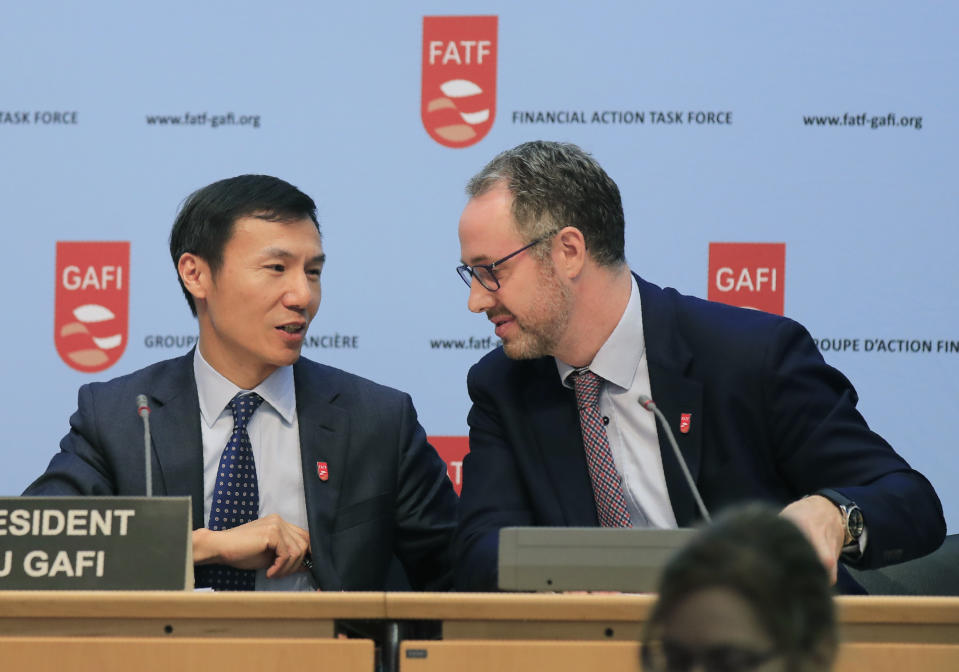 Financial Action Task Force (FATF) President Xiangmin Liu, left, and Executive Secretary of the FATF David Lewis talk to each other after a media conference at the OECD headquarters in Paris, Friday, Oct. 18, 2019. FATF a international monitoring agency has given Pakistan four months to prove it is fighting terrorism financing and money laundering or it could be put on a damaging global blacklist. (AP Photo/Michel Euler)