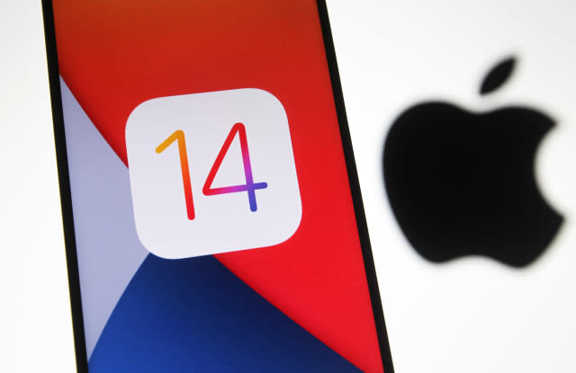 UKRAINE - 2020/10/14: In this photo illustration the iOS 14 logo of the iOS mobile operating system is seen displayed on a mobile phone with an Apple logo in the background. (Photo Illustration by Pavlo Gonchar/SOPA Images/LightRocket via Getty Images)