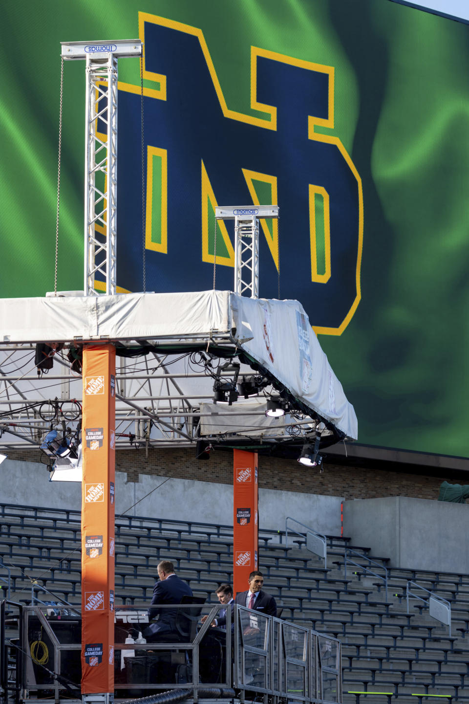 ESPN College Gameday host David Pollack, right, looks out toward the field as they prepare for their live broadcast from Notre Dame Stadium before the NCAA college football game between the Notre Dame and the Clemson in South Bend, Ind. (Matt Cashore/Pool Photo via AP)