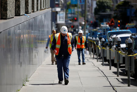 A worker with Pacific Gas and Electric (PG&E) walks on Eddy Street after a fire broke out at a substation in San Francisco, California, U.S., April 21, 2017. REUTERS/Stephen Lam