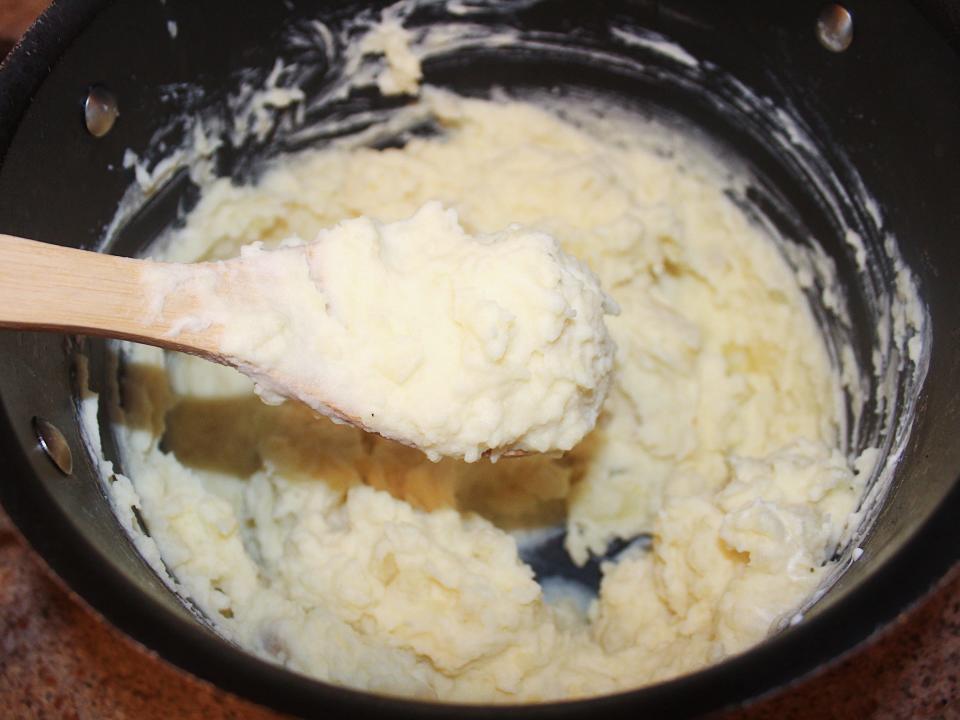 mashed potatoes and a wooden spoon