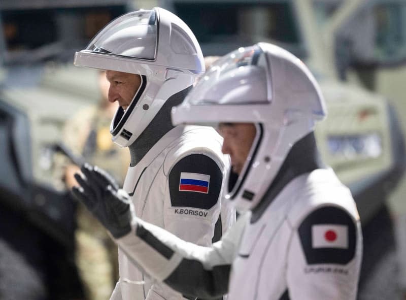 Roscosmos cosmonaut Konstantin Borisov, left, and JAXA astronaut Satoshi Furukawa, right, wave to loved ones as they join fellow Crew-7 teammates on departure from the Neil Armstrong Operations and Checkout Building to board the SpaceX Dragon spacecraft for the Crew-7 mission launch at the Kennedy Space Center, 2023 in Cape Canaveral, Florida. Joel Kowsky/Nasa/Planet Pix via ZUMA Press Wire/dpa