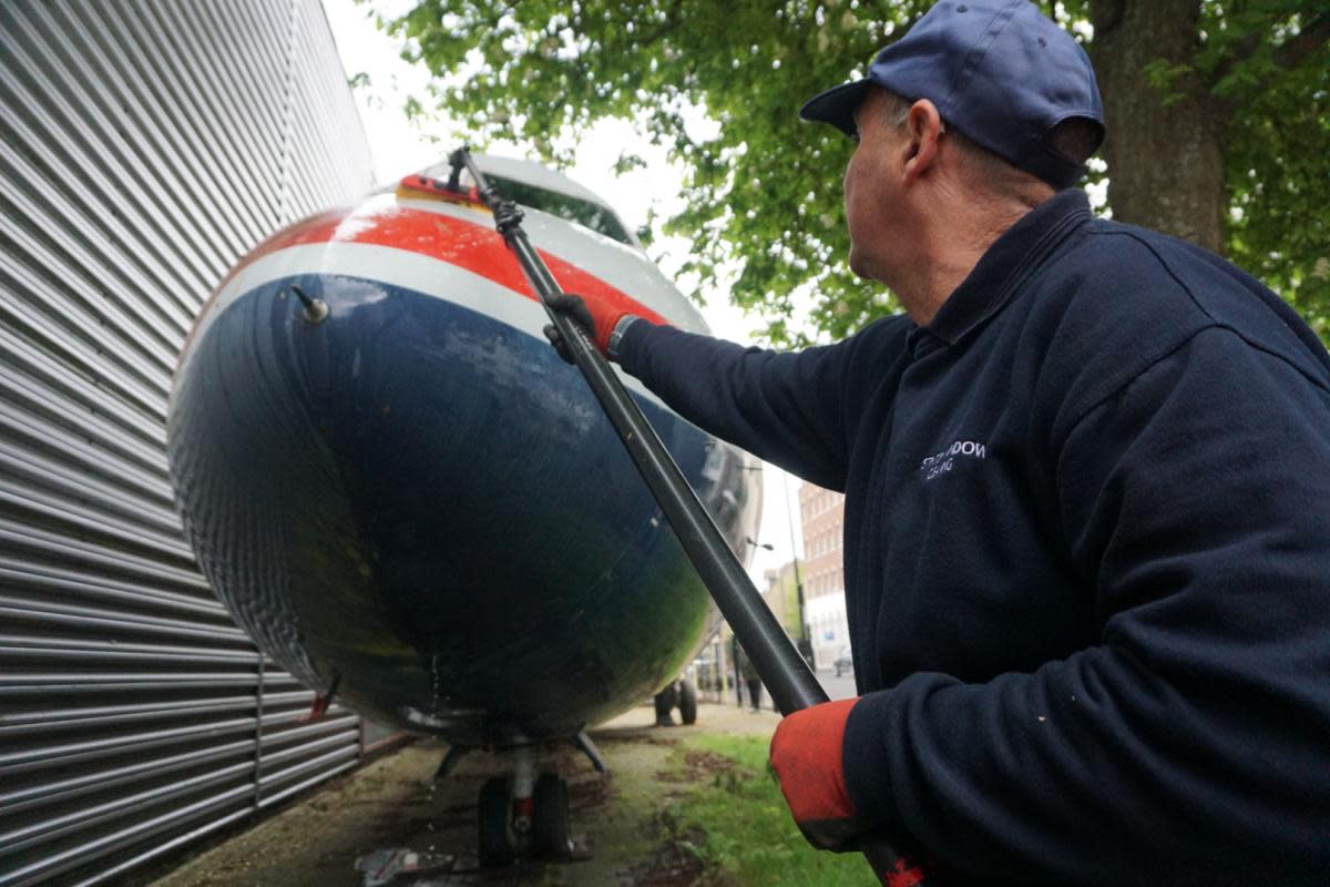 Andy Stinton cleaning the BAC 1-11 jet <i>(Image: Newsquest, Jose Ramos)</i>