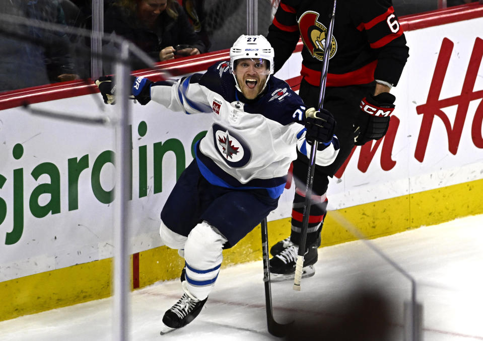 Winnipeg Jets left wing Nikolaj Ehlers (27) celebrates game-winning goal during overtime in an NHL hockey game against the Ottawa Senators, Saturday, Jan. 20, 2024, in Ottawa, Ontario. (Justin Tang/The Canadian Press via AP)