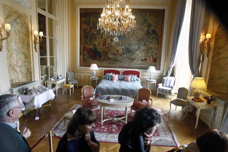 Visitors take a look at furniture displayed for auction at the Crillon Hotel in Paris, Monday April 15, 2013. Located Place de la Concorde, the Crillon hotel will put most of its furniture and some of his fine wines under the hammer next week, before a two-year restauration.(AP Photo/Remy de la Mauviniere)