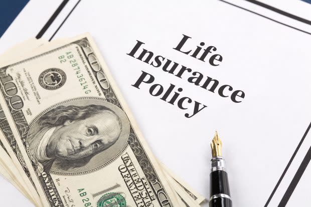 Life Insurance policy with money and a pen