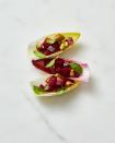 <p>In a bowl, toss 6 oz cooked beets (cut into 1/4-inch pieces), 1 Tbsp olive oil, 1/2 tsp orange zest and 1/8 tsp each salt and pepper. Fold in 1/4 cup green olives (chopped), then spoon onto endive leaves and sprinkle with chopped basil.</p>