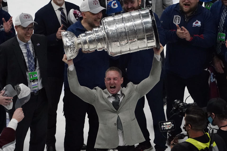 Colorado Avalanche head coach Jared Bednar lifts the Stanley Cup after the team defeated the Tampa Bay Lightning 2-1 in Game 6 of the NHL hockey Stanley Cup Finals on Sunday, June 26, 2022, in Tampa, Fla. (AP Photo/John Bazemore)