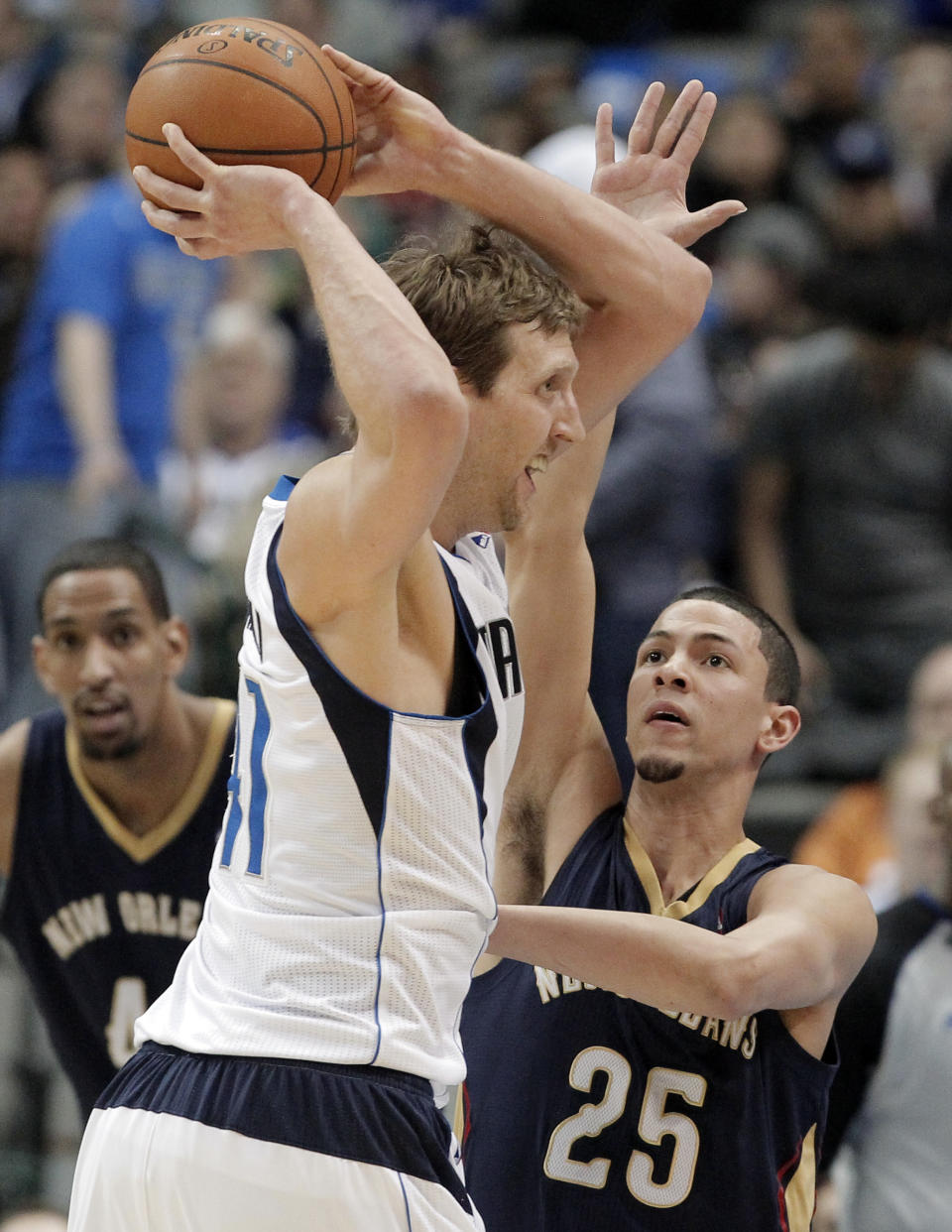 Dallas Mavericks' forward Dirk Nowitzki (41) looks to pass as New Orleans Pelicans' Austin Rivers (25) defends during the first half of an NBA basketball game on Wednesday, Feb. 26, 2014, in Dallas. (AP Photo/Brandon Wade)