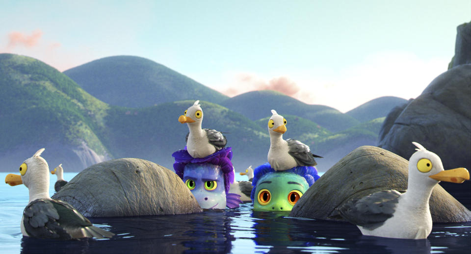 This image released by Disney shows characters Alberto, voiced by Jack Dylan Grazer, center left, and Luca, voiced by Jacob Tremblay, as they are surrounded by seagulls in a scene from the animated film "Luca." (Disney via AP)