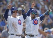 Aug 10, 2018; Chicago, IL, USA; Chicago Cubs first baseman Anthony Rizzo (44) and Chicago Cubs second baseman Javier Baez (9) celebrate after scoring two runs against the Washington Nationals during the sixth inning at Wrigley Field. Mandatory Credit: Jim Young-USA TODAY Sports