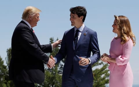Justin Trudeau and his wife Sophie Gregoire Trudeau greet Donald Trump, at the G7 summit, June 8  - Credit: Evan Vucci/AP