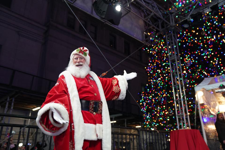 Santa Claus watches over the 98th annual Christmas tree lighting ceremony at the New York Stock Exchange on December 1, 2021 in New York.  (Photo by Brian R. Smith/AFP) (Photo by Brian R. Smith/AFP via Getty Images)