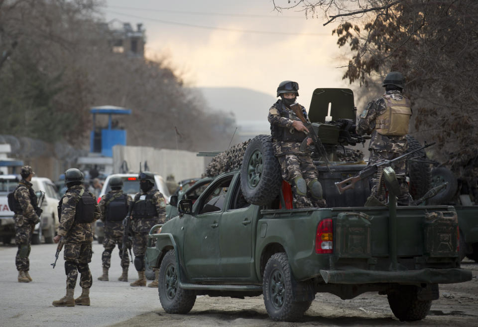Commandos with Afghanistan's intelligence agency arrive after four suicide bombers armed with assault rifles and hand grenades attacked an “office of foreigners” in a southwestern neighborhood of Kabul, Afghanistan, Friday, March 28, 2014. A Taliban spokesman said insurgents attacked a “guest house of foreigners and a church of foreigners.” His claim could not be immediately confirmed. (AP Photo/Anja Niedringhaus)