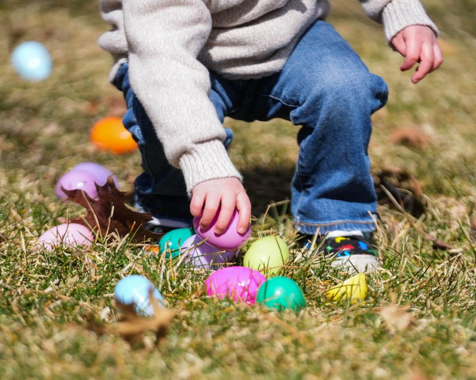 Charles North, 2, picks up plastic eggs during the annual Egg Hunt on the Hill at Iowa Governor's Mansion, Terrace Hill in Des Moines on Saturday, April 1, 2023.