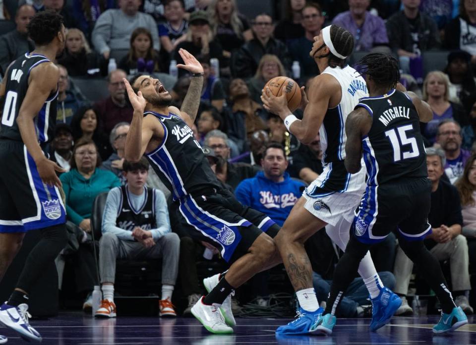 Sacramento Kings forward Trey Lyles (41) is fouled by Orlando Magic forward Paolo Banchero (5) during an NBA game Wednesday, Jan. 3, 2024, at Golden 1 Center.