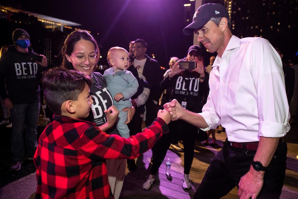 Democrat Beto O’Rourke fist bumps Nicolas Bucchioni, with Vanessa Maciel, holding her baby, Santiago, as he greets supporters during a rally at Discovery Green as he announces campaign for governor of Texas Friday, Nov. 19, 2021 in Houston.