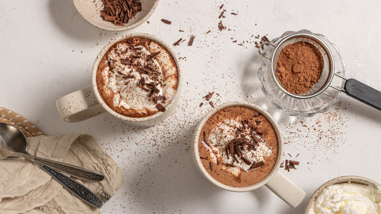 Two cups of espresso hot chocolate with garnishes