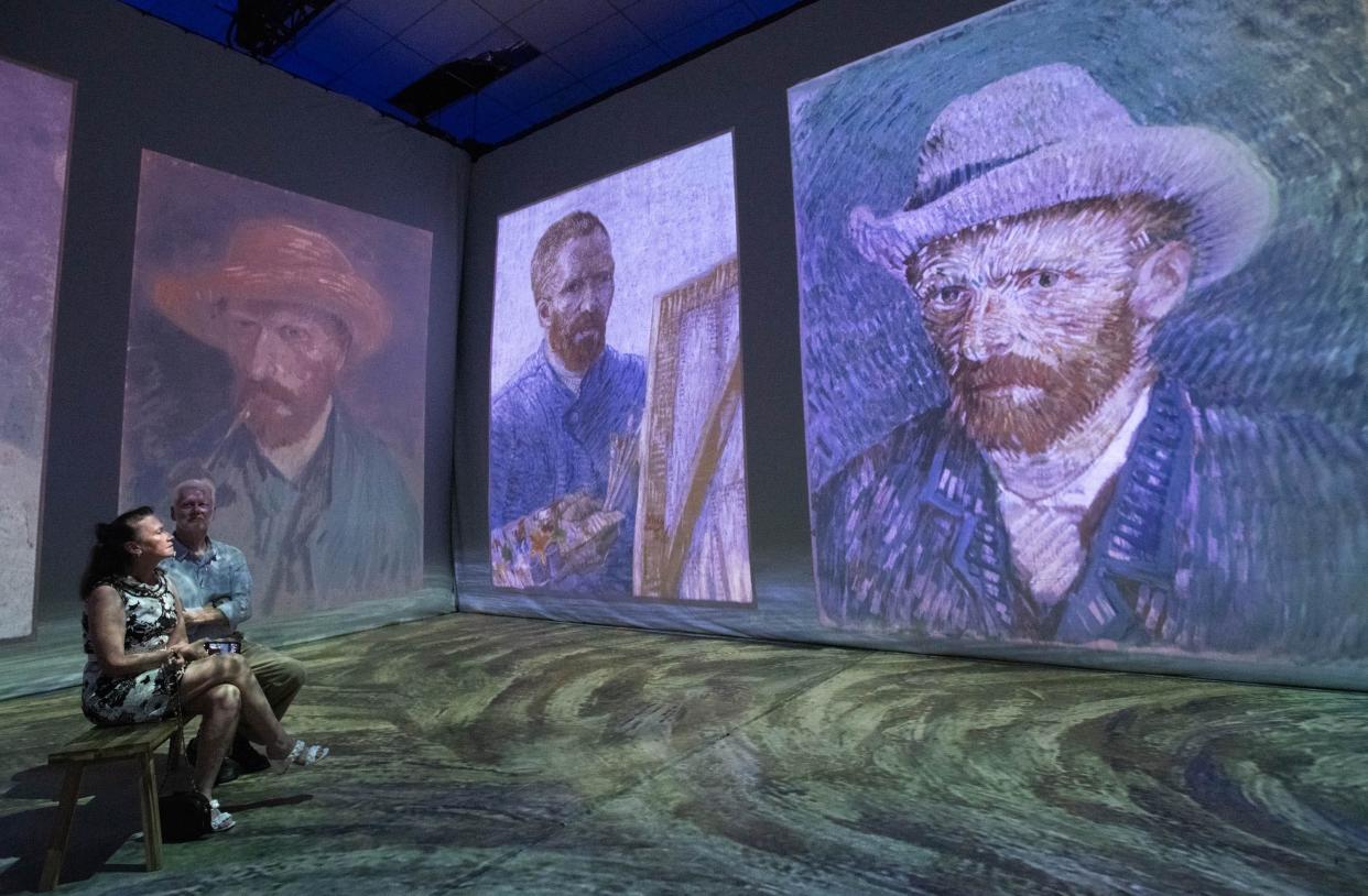 Donna and Joe Cleveland, of Daphne, Alabama, soak in the "Beyond Van Gogh: The Immersive Experience" on Aug. 7 at the Pensacola Interstate Fairgrounds in Florida.
