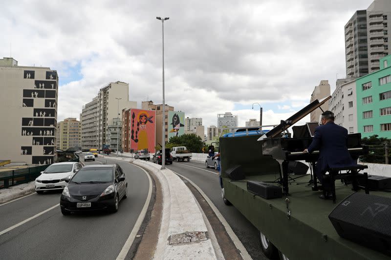 Pianist Rodrigo Cunha serenades from an open truck, in Sao Paulo