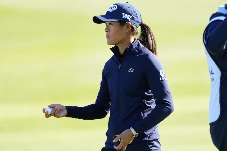 Celine Boutier, of France, hands her ball to her caddie on the third during the Drive On Championship golf tournament, Thursday, March 23, 2023, in Gold Canyon, Ariz. (AP Photo/Matt York)