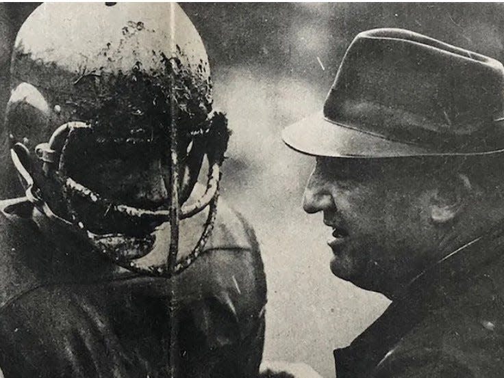 Gardner High head football coach Walt Dubzinski Sr. (right) gives some words of encouragement to his son and Wildcats captain John Dubzinski during a break in a game against Leominster High in 1965 at Stone Field. The younger Dubzinski, a center for Gardner, scored a pair of defensive touchdowns as the Wildcats won, 20-6.