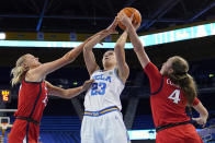 UCLA forward Gabriela Jaquez, center, shoots as Arizona guard Madison Conner, right, and forward Cate Reese defend during the first half of an NCAA college basketball game Friday, Feb. 3, 2023, in Los Angeles. (AP Photo/Mark J. Terrill)