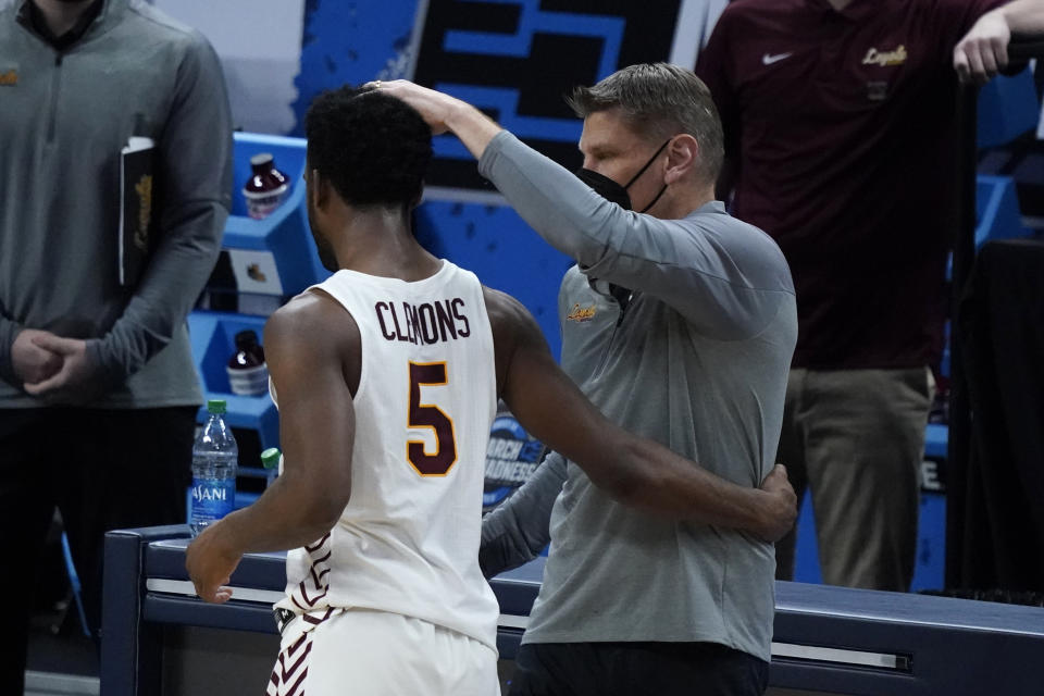 Loyola Chicago head coach Porter Moser, right, reacts with guard Keith Clemons (5) after a Sweet 16 game against Oregon State in the NCAA men's college basketball tournament at Bankers Life Fieldhouse, Saturday, March 27, 2021, in Indianapolis. Oregon State won 65-58. (AP Photo/Jeff Roberson)