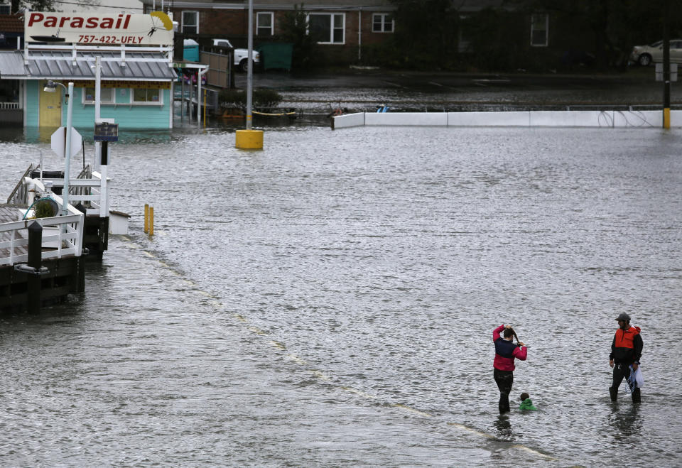 Jon Baranowski and his family play in the flooded parking lot of the Virginia Beach Fishing Center in Virginia Beach, Va., as Hurricane Dorian passes through Hampton Roads on Friday, Sept. 6, 2019. (Stephen M. Katz/The Virginian-Pilot via AP)