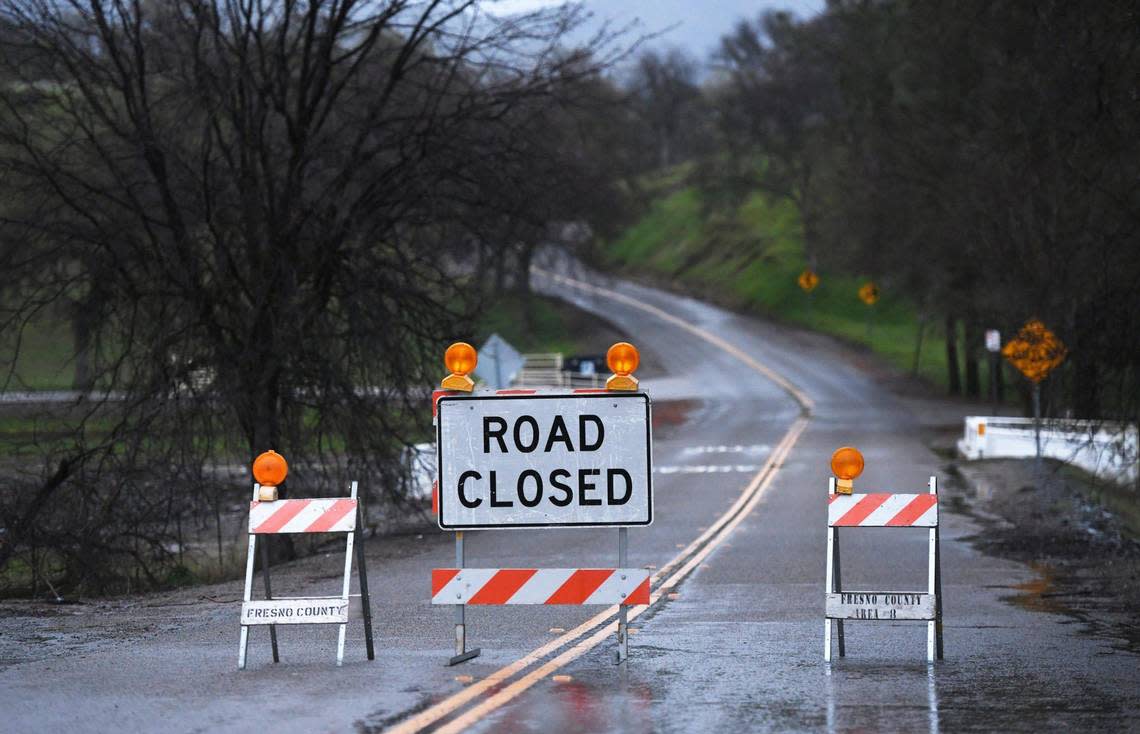 Pine Flat Road, leading to Pine Flat Dam, is seen closed outside the Piedra Post Office and near the Choinumni Park entrance Thursday, March 9, 2023 east of Fresno.